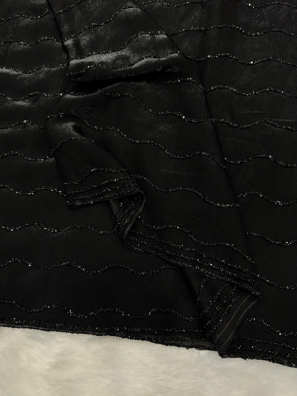 Black diamond work bring out the vibrancy of this black space silk saree.