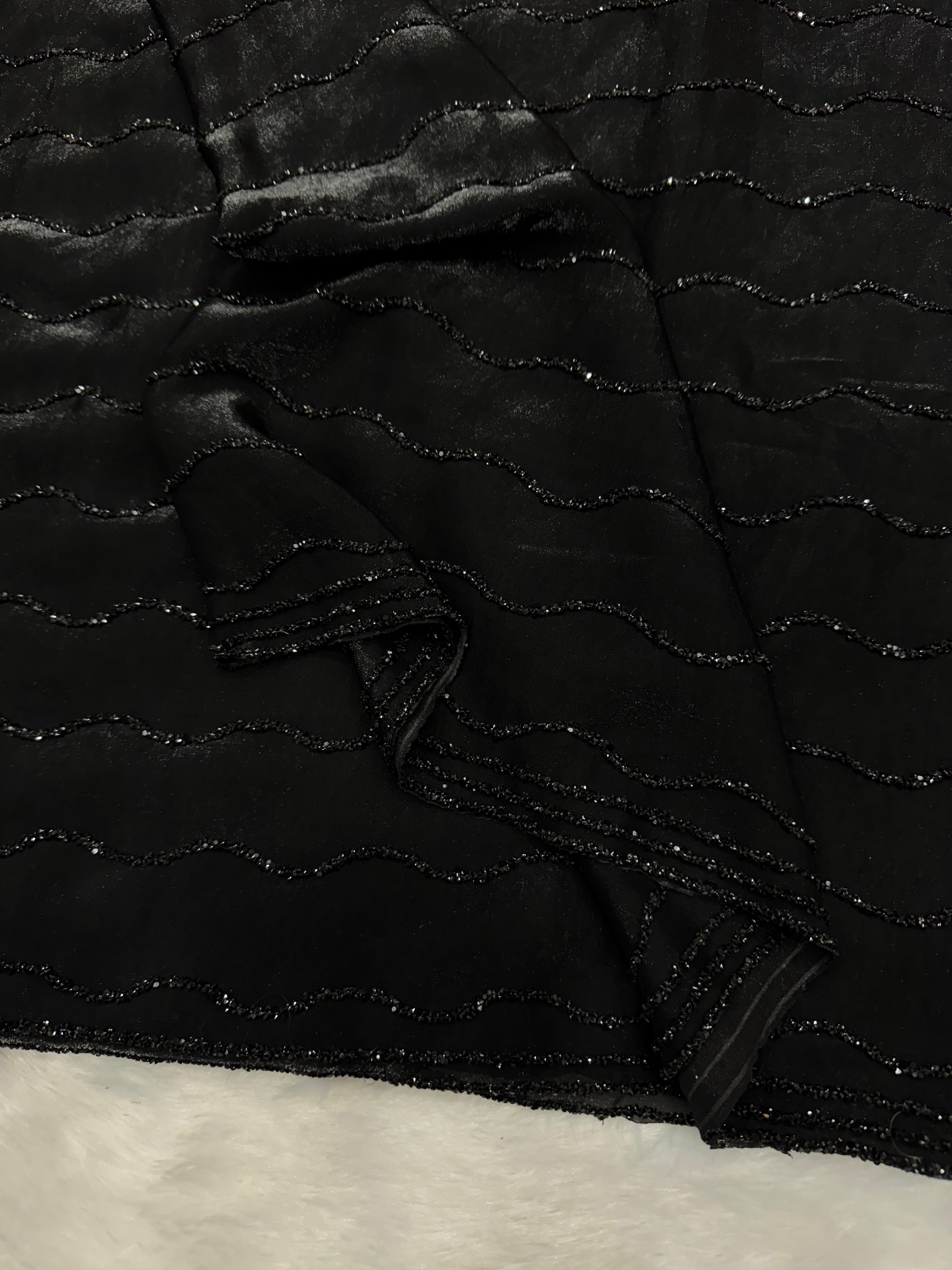 Black diamond work bring out the vibrancy of this black space silk saree.