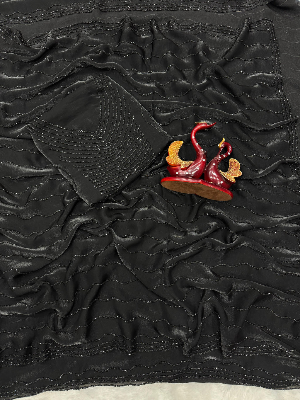 Black diamond work bring out the vibrancy of this black space silk saree.